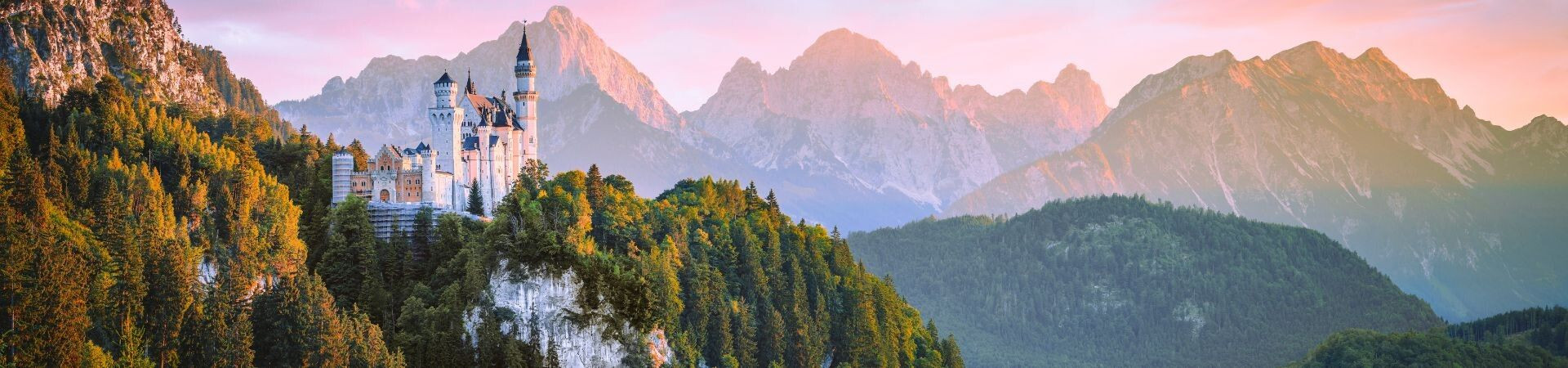 Château de Neuschwanstein au coucher du soleil devant les Alpes - Bavière - Allemagne
