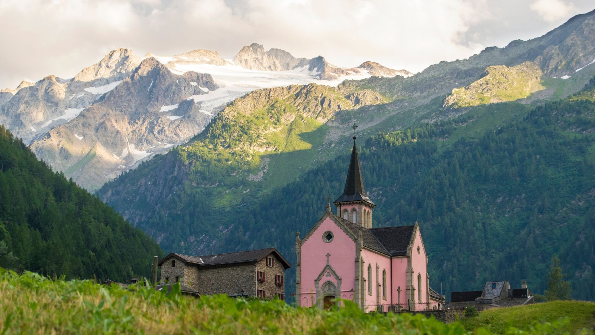 Église rose de Trient et chalets de pierre sous les glaciers - Valais - Suisse